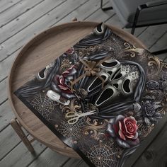 a wooden table topped with a mask and roses