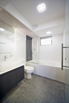 a bathroom with a toilet, sink and bathtub