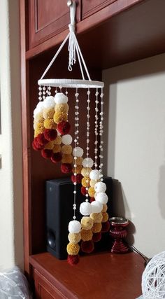 a teddy bear mobile hanging from a shelf in a room with other items on it