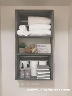 the shelves in the bathroom are organized with towels and other items to keep them clean