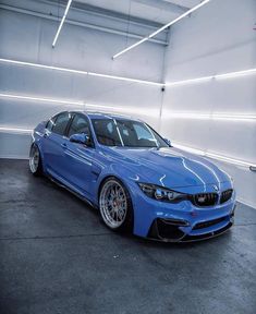 a blue car parked in a parking garage