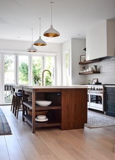 a kitchen with wooden floors and white walls