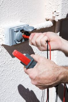 an electrician is working on the electrical wires in his house royalty images and stock photos