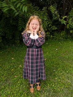 This black plaid dress is great for little girls at play or those who want to dress up. this is made from a flannel fabric so it will stay nice and warm on these colder days. There is a Peter Pan collar and a tie in the back for all those little girls who grew up so fast. This is a vintage inspired dress made off of a vintage pattern. There is a zipper in the back for the closure. Shipping is included in the price This is a size 6 Waist 30" Collar 15" around  Growth pleat 1" Fitted Plaid School Dress, Fitted Plaid Dress For School, Cute Plaid Dresses For School, Preppy Plaid Dress For Fall, Fitted Plaid Preppy Dress For Fall, Fitted Plaid Dress For Fall In Preppy Style, Fitted Plaid Dress For Fall, Preppy Style, Black School Dresses For Fall, Black Fall Dresses For School