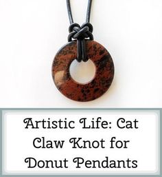 an artistic life cat claw knot for donut pendants on a black cord necklace