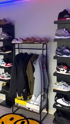 a rack filled with lots of shoes next to a yellow smiley face rug on the floor