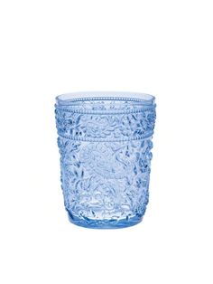 a blue glass vase sitting on top of a white table