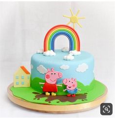 a peppa pig birthday cake with a rainbow on top