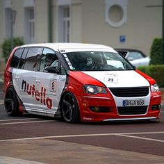 a red and white van driving down the street