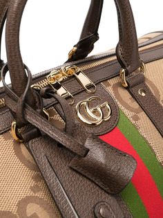 Jumbo GG duffle bag from Gucci featuring multicolour, calf leather, leather trim, gold-tone logo plaque, signature Web-stripe dial, monogram pattern, leather top handles, adjustable detachable shoulder strap, top zip fastening and main compartment. This item is in size UNI and the color is Beige High-end Travel Satchel With Branded Hardware, Luxury Monogram Canvas Satchel For Travel, Gucci Rectangular Satchel With Branded Hardware, Monogram Canvas Satchel For Travel, Travel Satchel In Monogram Canvas, Gucci Brown Satchel With Top Carry Handle, Brown Gucci Satchel With Top Carry Handle, Designer Rectangular Duffle Bag With Zipper Closure, Designer Double Handle Duffle Bag