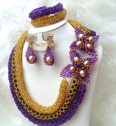 PrestigeApplause 3 Layers Latest Purple Mixed with Gold Wedding Bridal African Nigerian Beads Jewellery Set Complete Set is Necklace, Earring and bracelet Wedding Party Bridal Special Occasion We can make any color to your specification  This detailed Jewellery set makes you stand out elegantly in any special occassion, it's all about glamour and uniqueness.  Buying more that 1 Jewellery set, we offer wholesale and bulk prices for all our jewellery. Elegant Flower Beaded Necklace For Wedding, Purple Beaded Jewelry For Wedding, Elegant Purple Beaded Necklace For Wedding, Nigerian Beads, Coral Jewelry Set, Jewelry Styles, Bridal Necklace Set, Bracelet Wedding, Beads Jewellery