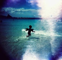 a young child is running through the water