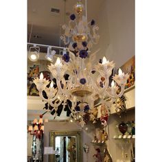 a chandelier hanging from the ceiling in a room with other items on display