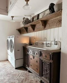 a washer and dryer in a room with brick flooring on the walls