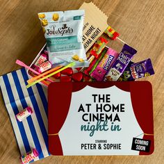 the at home cinema night in sign is surrounded by snacks and candy