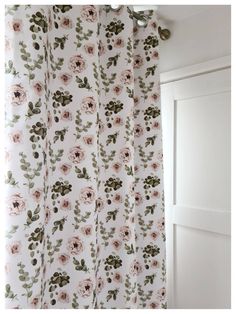 a white curtain with pink and green flowers on it