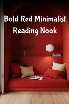 Bold red minimalist reading nook with cushions, a book, and a hanging light.