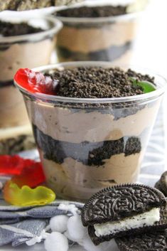 oreo cookies and ice cream desserts in plastic cups on a white tablecloth