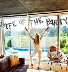 a woman standing in front of a sliding glass door with the words state of the party written on it