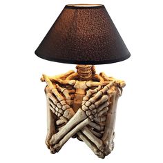 a lamp that is sitting on top of a wooden structure with bones and bones in it