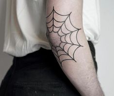 a man with a spider web tattoo on his arm