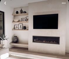 a large flat screen tv mounted to the side of a wall in a living room