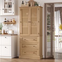 a wooden cabinet sitting in the middle of a kitchen