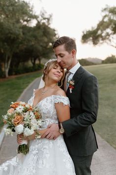 a bride and groom pose for a wedding photo