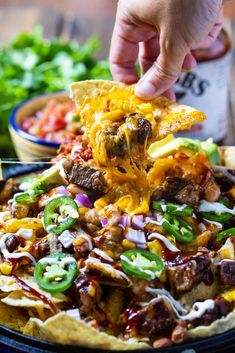 a person dipping some food into a bowl