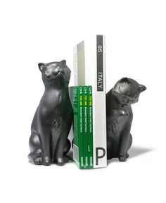 two black cat figurines sitting next to each other