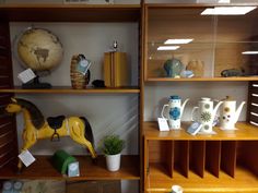 shelves with vases, cups and figurines on them