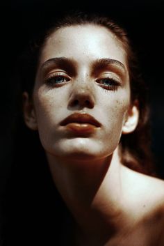 a woman with freckles on her face and eyes