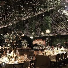 the tables are set with candles, flowers and greenery for an elegant wedding reception