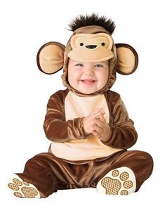 a baby wearing a monkey costume sitting on the ground