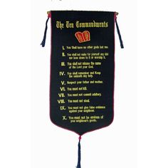 the ten commandments banner hanging from a hook with tassels on it's sides