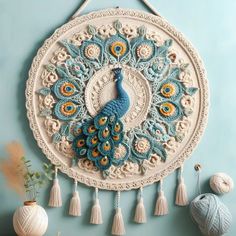 there is a wall hanging made with yarn and crochet, it looks like a peacock