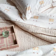 an empty ring box sitting on top of a bed