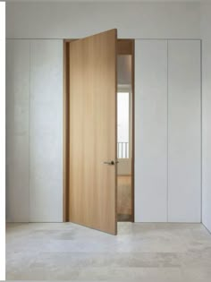 an open wooden door in a white room