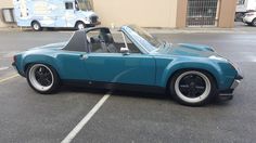 a blue sports car parked in a parking lot