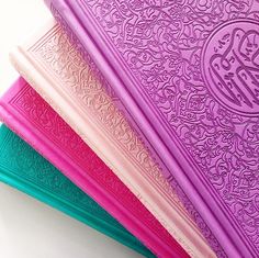 five different colored books with arabic writing on them