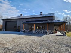 a large metal building sitting on top of a gravel lot