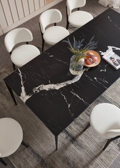 a black table with white chairs around it