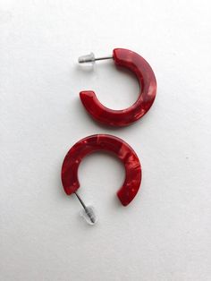 "These red acetate hoops are so easy to wear! Light weight yet slightly chunky to make a statement.  The acetate is a marbled mix of reds. Perfect for Valentine's Day and beyond!  They are less then 1\" in diameter." Small Hoop Red Earrings For Everyday, Red Small Hoop Earrings For Everyday, Small Red Hoop Earrings For Everyday Wear, Trendy Small Hoop Plastic Earrings, Trendy Small Hoop Red Earrings, Trendy Red Plastic Jewelry, Trendy Red Hoop Earrings, Trendy Red Resin Earrings, Trendy Small Hoop Resin Earrings