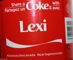 a close up of a can of coke with the label's name on it