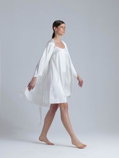 Long silk robe and nightgown set 'Meteya&Aphrodite' in milk white is designed for the most special moments of your life. The delicate silhouette of the midi dress 'Aphrodite' with a flare design and adjustable straps for a customizable fit has an elegant and feminine look that captivates with every step. The set comes with a collarless silk robe 'Meteya' with pockets for an added touch of practicality. The robe's belt has feather accents that provide a subtle yet luxurious detail that elevates t Elegant Silk Nightgown For Spring, Elegant Spring Silk Nightgown, White Silk Wedding Nightgown, White Silk Sleepwear For Spring, White Silk Dress For Sleep, White Silk Sleep Dress, Elegant White Summer Nightgown, Elegant White Night Robe, Elegant Summer Sleep Robe