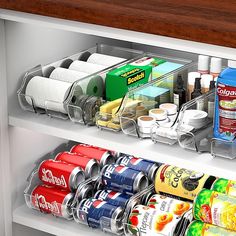 an organized pantry with canned food and condiments on the shelves, including cans