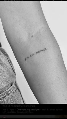 a person's arm with the words you are enough tattooed on their left arm