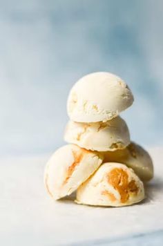 a pile of ice cream sitting on top of each other in front of a blue background