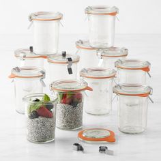 there are many glass containers with food in them