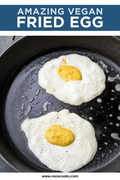 two fried eggs cooking in a frying pan